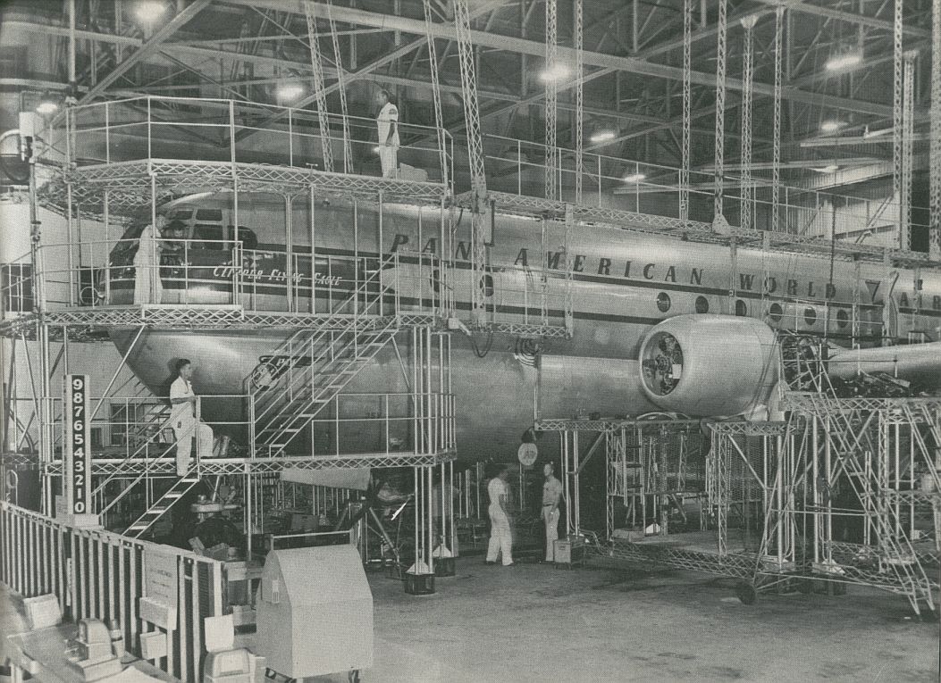 1956 A Pan Am Boeing 377 Stratocruiser in hanger maintenance scaffolding.